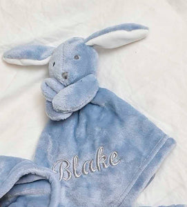 our Babies personalised bunny comforter in Dusky Blue is crafted from super soft plush material, this comforter will keep your baby snug and content. Complete with your babies name personalised/embroidered to the front.