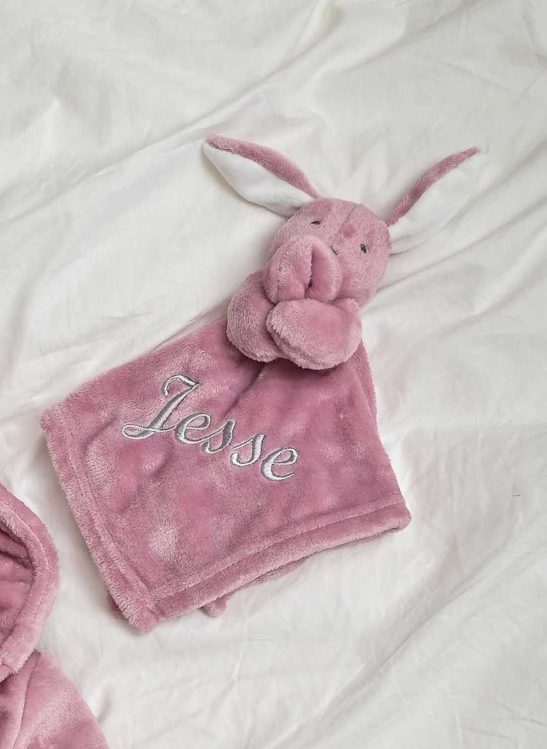 our Babies personalised bunny comforter in Dusky Pink is crafted from super soft plush material, this comforter will keep your baby snug and content. Complete with your babies name personalised/embroidered to the front.