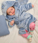 Load image into Gallery viewer,  Babies personalised Dusky Blue hooded dressing gown. Made from super soft material, it features an elephant embroidery to the chest as well as detailing pom pom ears and a hood. Make it extra special by adding a personalised touch.
